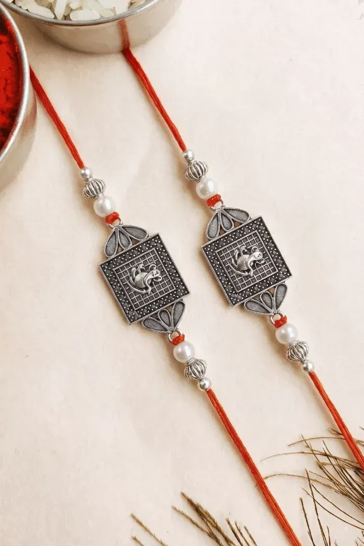Oxidised Silver Ganesha Pearl Rakhi Set with Red Thread Design