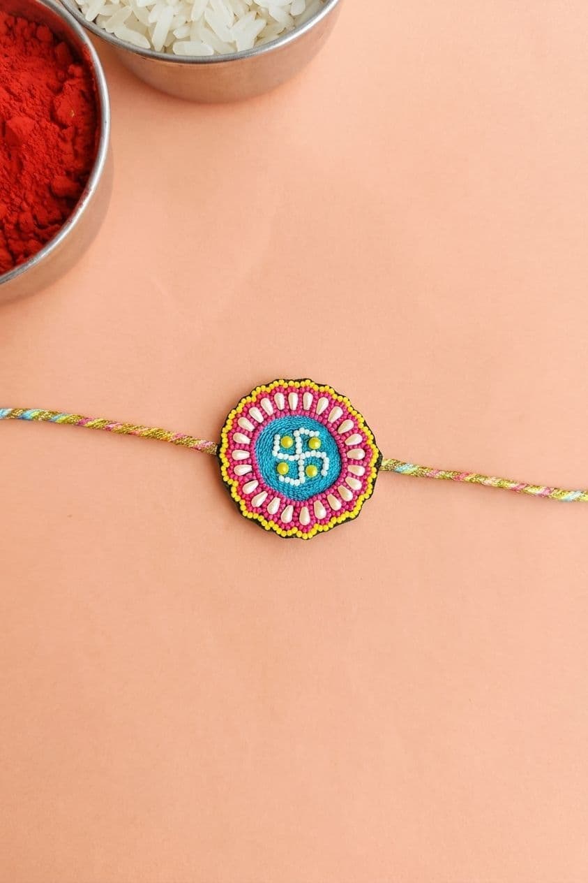 Handmade Swastik Rakhi with Colorful Beaded Floral Design