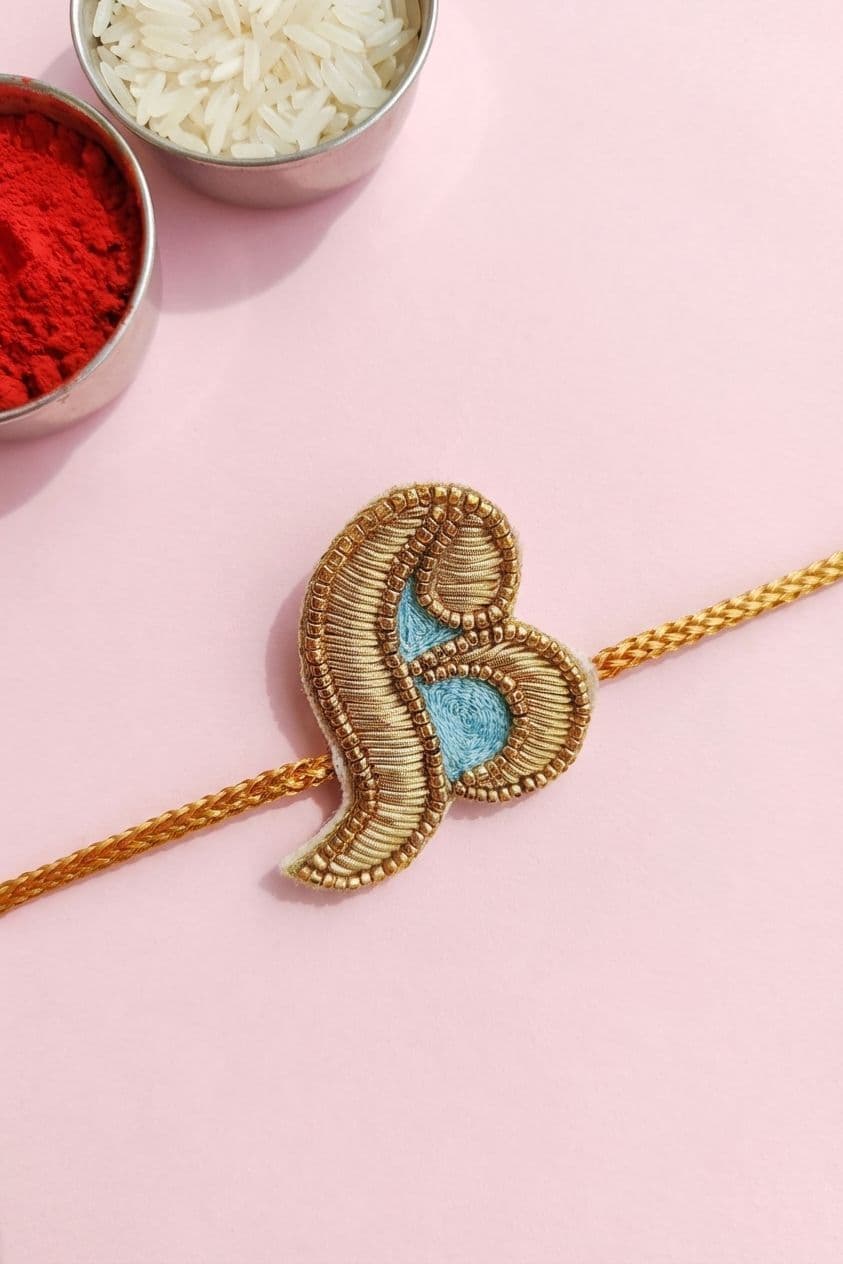 Golden Paisley Handmade Rakhi with Blue Embroidery
